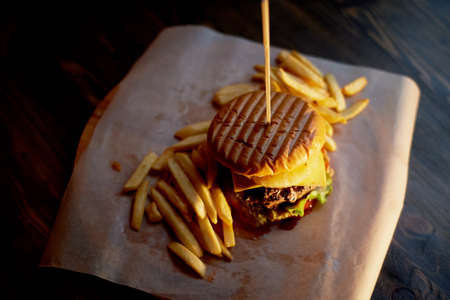 Wood top on her fries and Burger. The concept of the pub and fast foodの写真素材