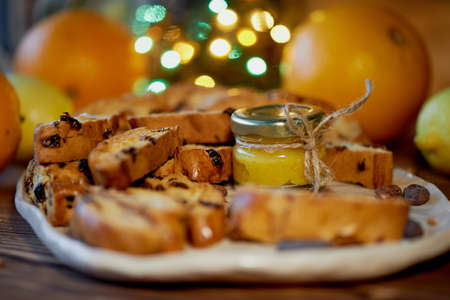 Cookie biscotti, a jar of honey and fruit. The atmosphere of warmth and coziness. New year atmosphereの写真素材