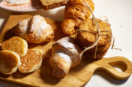 Fresh pastries for Breakfast. Oatmeal cookies, tied with jute rope, and pancakes . Rustic retro...