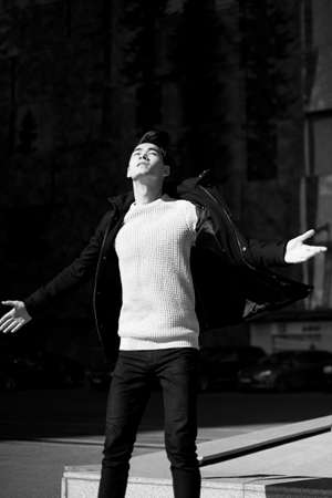 A young man with dark hair and eyes jumping. The feeling of freedom. Lifestyle. High growth.の写真素材