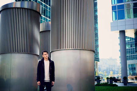 A young man, thin. With dark hair and brown eyes. Portrait. The model of attractive appearance. The concept of people in the city. Lifestyleの写真素材