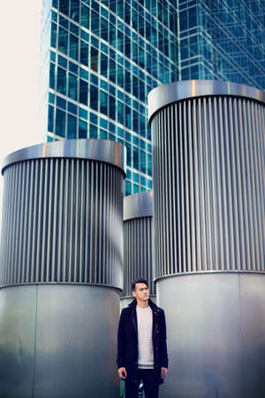 A young man, thin. With dark hair and brown eyes. Portrait. The model of attractive appearance. The concept of people in the city. Lifestyleの写真素材