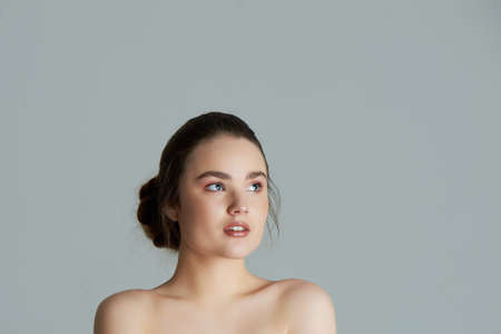 Beauty portrait of beautiful young brunette with clean skin. Care about beauty and health.