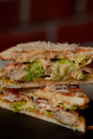 A delicious sandwich with salad and chicken. Sprinkled with cheese. A quick delicious Breakfastの写真素材