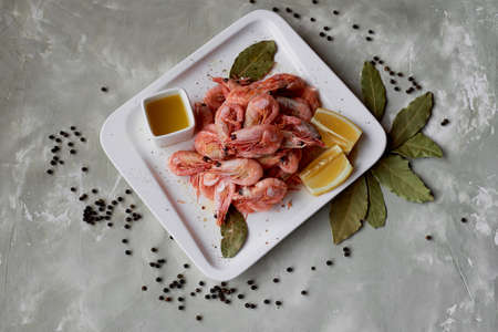 Boiled shrimp with pepper and Lavrushka. With the lemon slices and sauceの写真素材