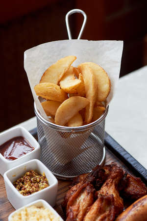 German hearty lunch in the pub. Grilled sausages, stewed cabbage, croutons, sauce. Beer snackの写真素材