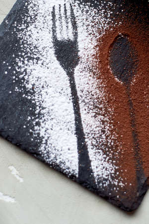 The outline of the fork and spoon , sprinkled with cocoa powderの写真素材
