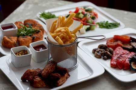 Nice table in the restaurant. Hearty and tasty lunch consisting of cheese Camembert in batter, Greek...