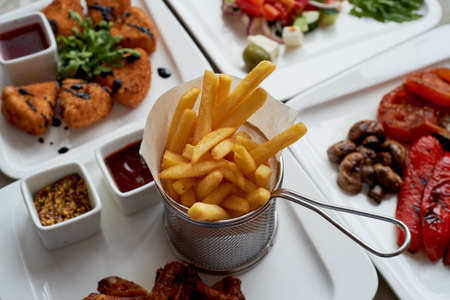 Nice table in the restaurant. Hearty and tasty lunch consisting of cheese Camembert in batter, Greek...
