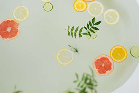 Milk water in the bath, which swim citrus: lime, lemon and grapefruit. Skin care and relaxationの写真素材