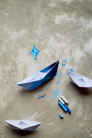 Dreams about the sea. A symbol of travel and freedom. A ship made of paper. Pastel crayons.