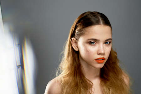 Portrait of young beautiful girl in Studio, with professional makeup. Beauty shooting. The warm...