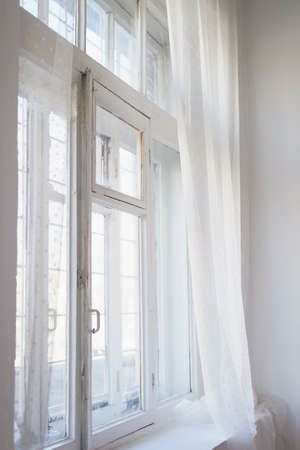White painted window with old wooden frame. The interior of the apartment or house. Daylightの写真素材