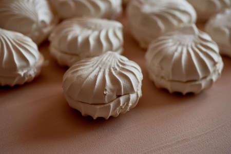 Lots of marshmallows on a cream background.