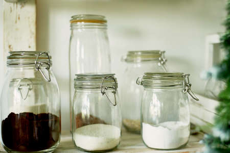 Glass jars with bulk products: salt, sugar, coffee . With tight lids. Kitchen storageの写真素材