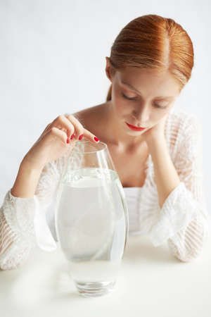 Beautiful girl of European appearance. Red hair with a touch of honey.Beauty shooting. A container...