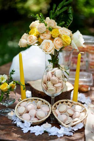 Catering for the wedding Banquet.Macaroons in vases, cream and yellow flowersの写真素材