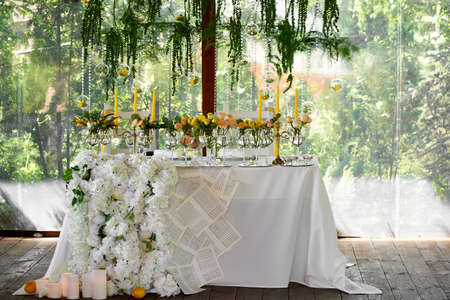 Wedding table decoration. Wedding flowers in yellowの写真素材