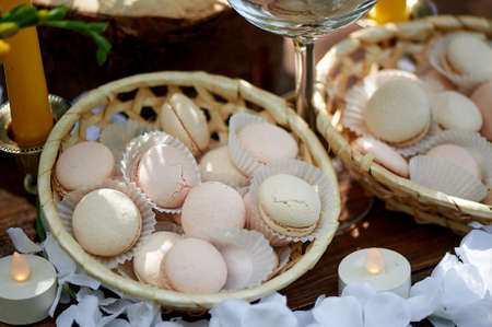 Catering for the wedding Banquet.Macaroons in vases, cream and yellow flowers