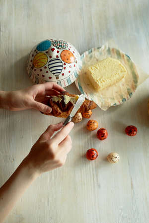 Light aesthetic French Breakfast. The girl is buttering a croissant with butter. In the frame of the handの写真素材