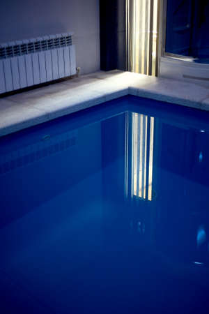 The water in the pool inside the room. Visible part of the rim of stone. Sports, Spa