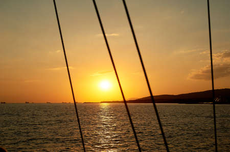 Golden sunset on the sea. Path on the water. Beautiful Golden lightの写真素材