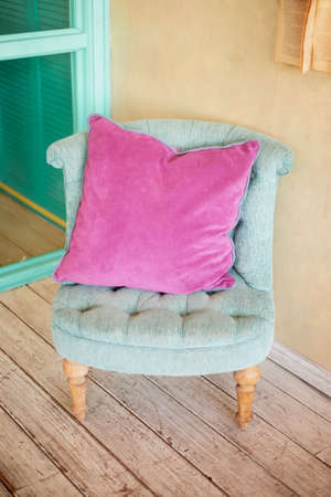 Turquoise chair in pink pillow in pastel colors. Stylish interiorの写真素材