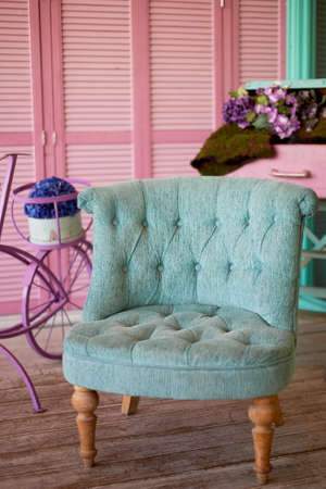 Turquoise chair in pink pillow in pastel colors. Stylish interiorの写真素材