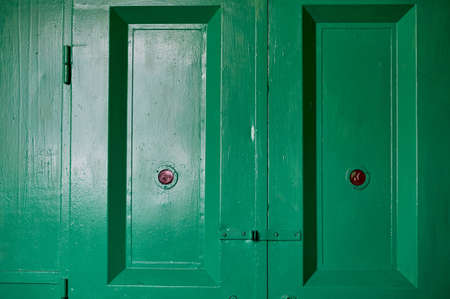 Green doors of an old freight Elevator in an industrial building. Old factory