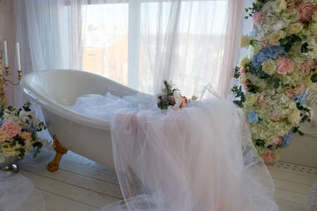 Bath on lions Golden paws. The atmosphere of romance and love. Light interior, chiffon, flowers.の写真素材