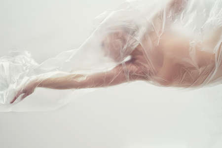 Gymnastics. The girl seems to float in a transparent film. Weightlessness, tenderness.の写真素材