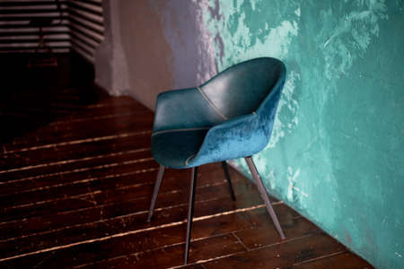 The chair on the textured background of the wall of turquoise and lilac. Smears. The style of minimalism.の写真素材