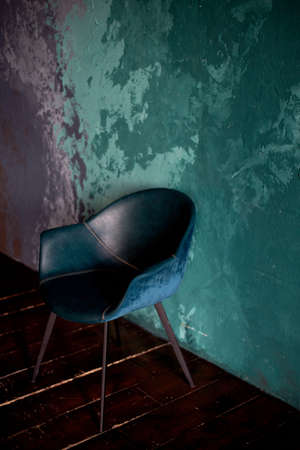 The chair on the textured background of the wall of turquoise and lilac. Smears. The style of minimalism.の写真素材