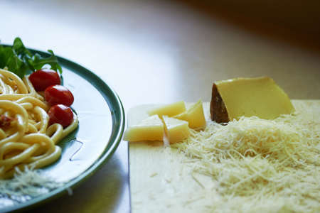 Pasta Carbonara with grated Parmesan cheese and cherry tomatoes, decorated with arugula. Italian lunch.の写真素材