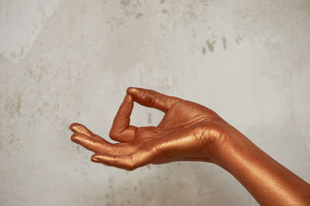 Hands in gold paint, the hands of the artist and creative person. Yoga for handsの写真素材