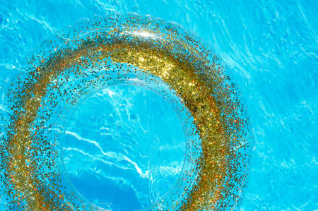 Blue water in the pool and a transparent circle with gold sequins. The atmosphere of rest on the...