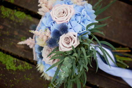 Bouquet of the bride with a powdery rose and blue hydrangea. Wedding florist.の写真素材