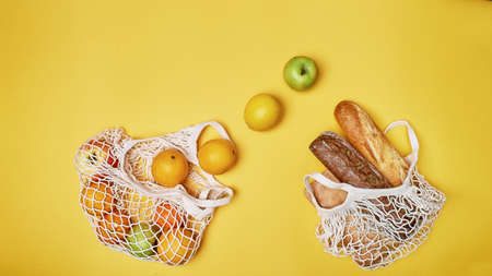 Replacing plastic bags. Taking care of the environment. Nets with products. Simple and useful. The fruit and bread.の写真素材