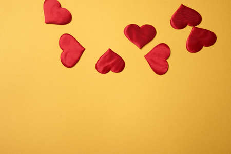 Valentines day, a Declaration of love.A few red hearts on an orange background. Free space at the...