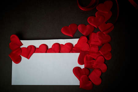 Valentines day, a Declaration of love.White envelope with red hearts. Valentine. On a dark gray background.の写真素材