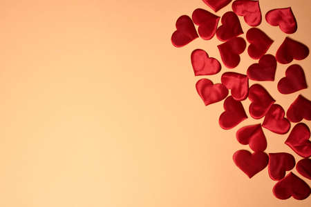 Valentine's day, a Declaration of love. Lots of red hearts on a peach background.