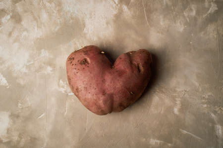 Ugly food, potatoes in the shape of a heart. Natural and simple farm products.の写真素材