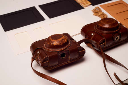 Storage and archiving of photos. Paper frames for photos, an old film camera in the case. Preserving your history. Photo Art.の写真素材