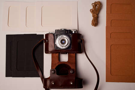 Storage and archiving of photos. Paper frames for photos, an old film camera in the case. Preserving...