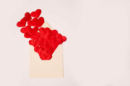 Kraft the envelope with red hearts on a white background. Congratulations on Valentines Day. Hearts...