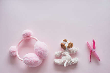 Childrens world girl. Pink background, toy, curling tongs and earbuds with pumpons.の写真素材