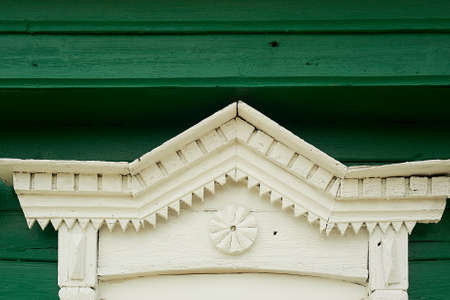 An old wooden house in a Russian village. Fragment of the tiles on the window. Historic building.の写真素材