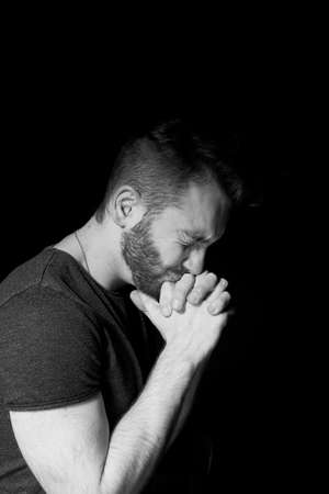 A man on a black background. Emotion of impotence, hopeless situation, trap.の写真素材