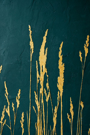 Green textured wall with a picture of grains of gold paint. Interior wall decorationの写真素材