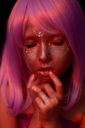 A girl with purple hair and glowing skin. An alien or a fairy with glowing skin. Eyes closed. Cute doll faceの写真素材